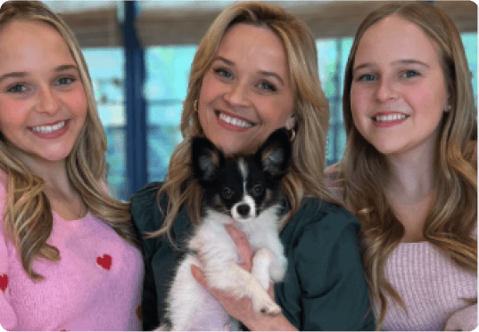 A group of women holding a dog