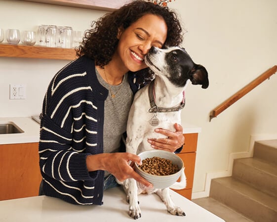a woman hugging her dog