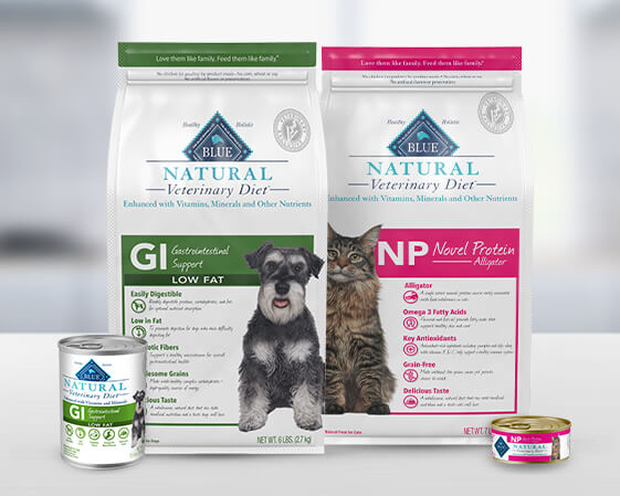 Two bags of Blue Natural Veterinary Diet dog food and two cans of wet food, displayed against a blurred background.