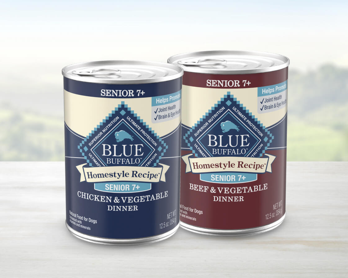 Two cans of Homestyle Recipe senior dog food, Chicken & Vegetable and Beef & Vegetable flavors.