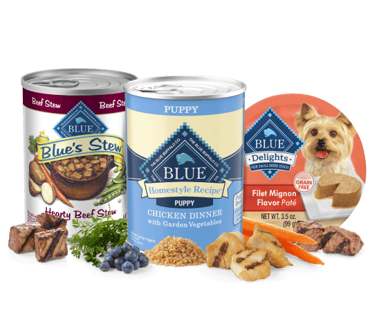 Three Blue Buffalo pet foods: Blue’s Stew Hearty Beef Stew can, BLUE Homestyle Recipe Puppy Chicken Dinner can, BLUE Delights Filet Mignon pâté cup