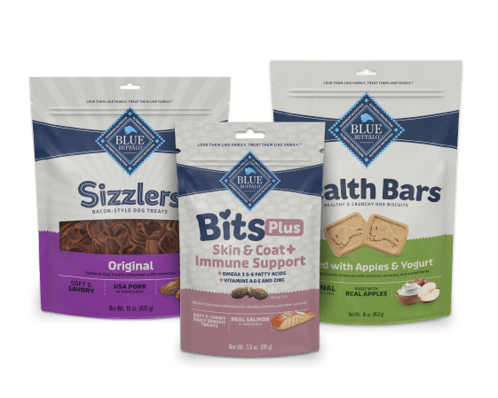 Three Blue Buffalo dog treat bags: Sizzlers Original bacon-style, Bits Plus Skin & Immune Support, and Health Bars baked with apples & yogurt