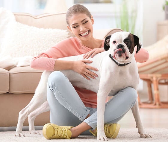 women and a dog sitting on the floor