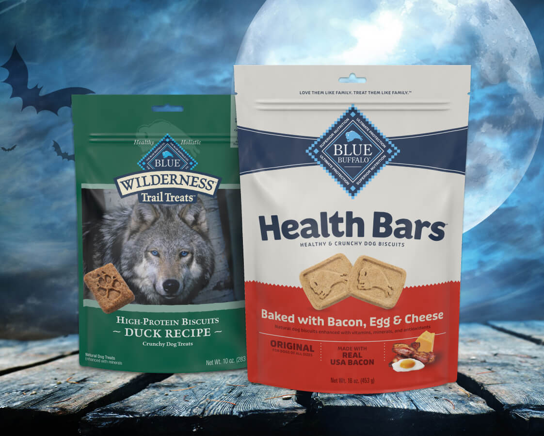 Blue Buffalo Crunchy dog treats packaging, showcasing natural ingredients with a Halloween-themed design and orange accents.