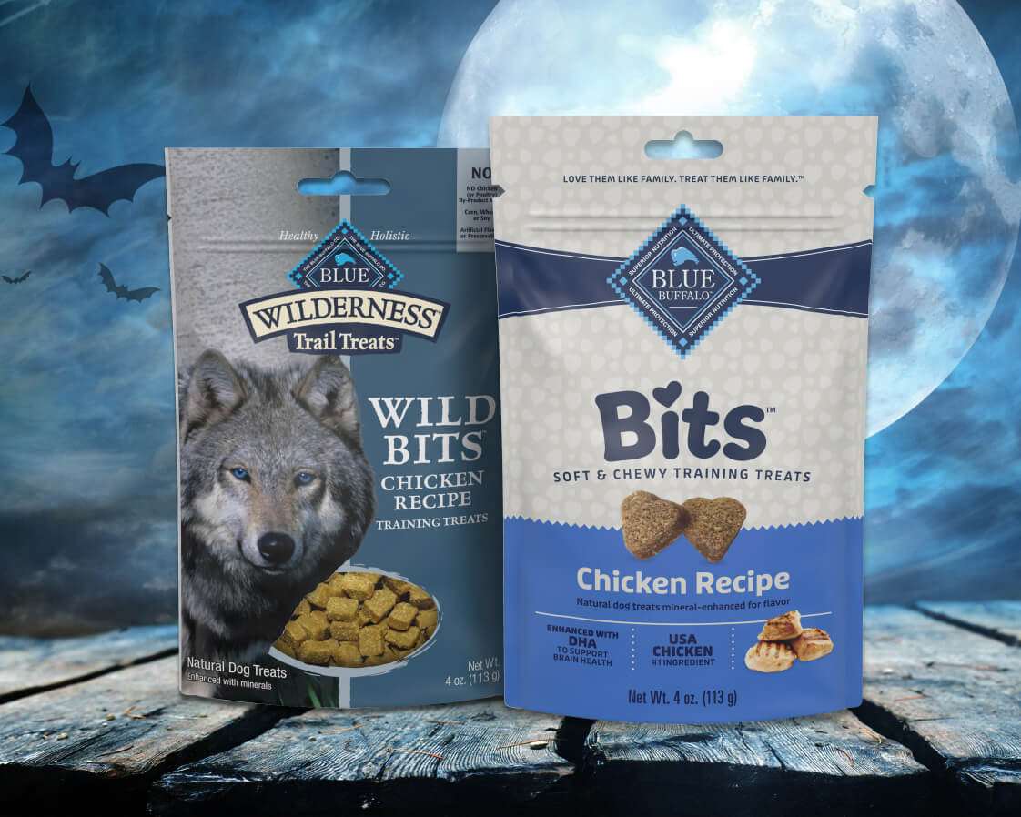 Blue Buffalo Training dog treats packaging with Halloween-themed design, highlighting natural ingredients for rewarding pets.
