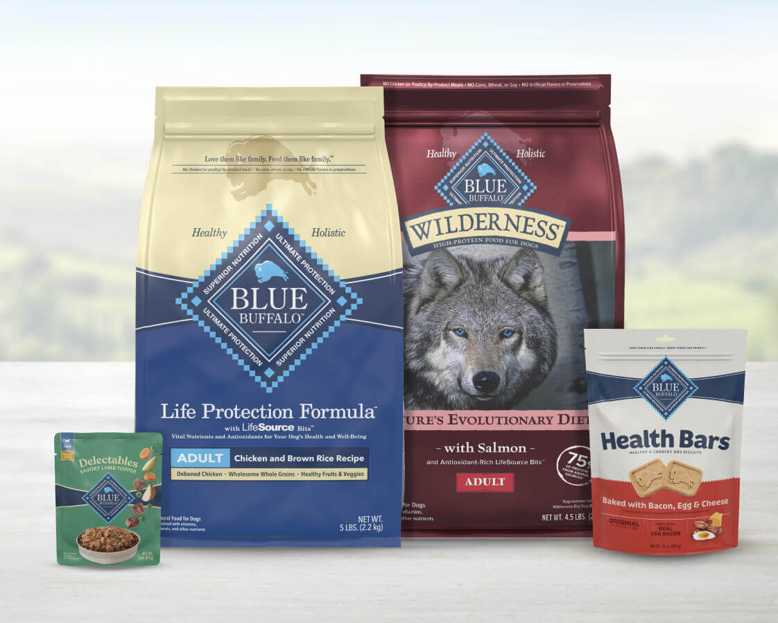 Two bags of BLUE dry dog food, a food topper, and a pack of BLUE Health Bars dog treats for adult dogs.