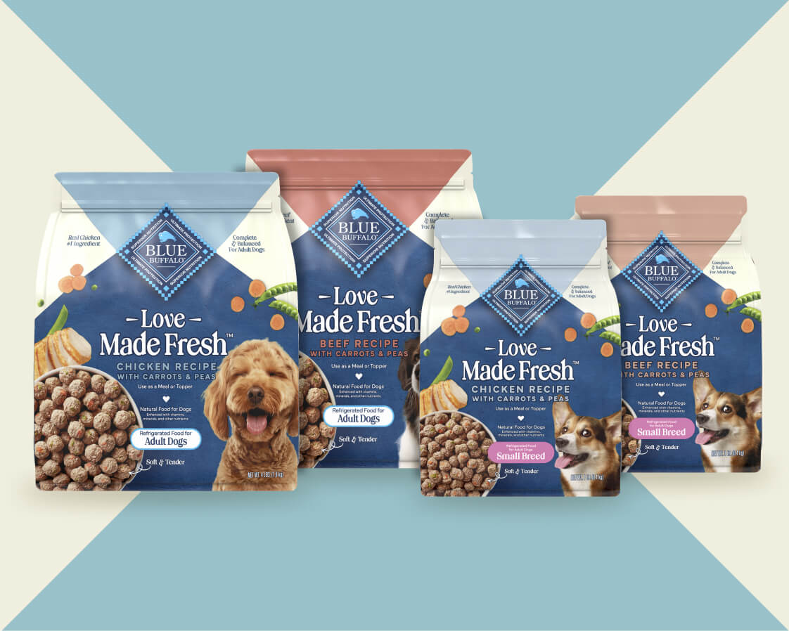 Four bags of Love Made Fresh dog food in different varieties sit against a geometric background.