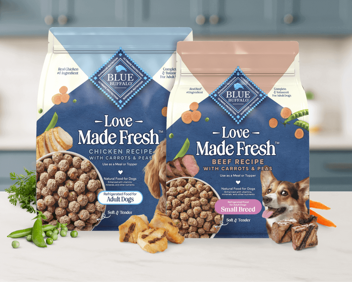 A BLUE recipe is shown next to tasty, real vegetables and tender cuts of meat on a kitchen counter.