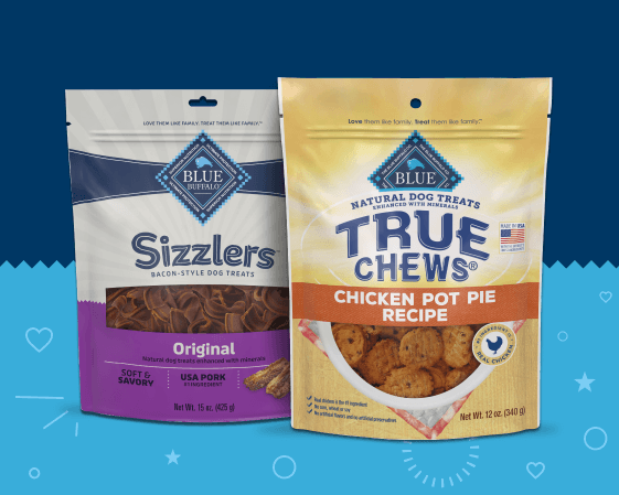 Two Blue Buffalo dog treat packages featuring Sizzlers bacon-style treats and True Chews chicken pot pie recipe treats.