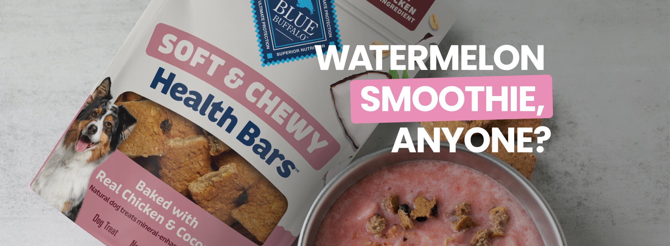 A bowl of pink smoothie topped with broken dog treats sits beside Health Bars dog treat boxes.