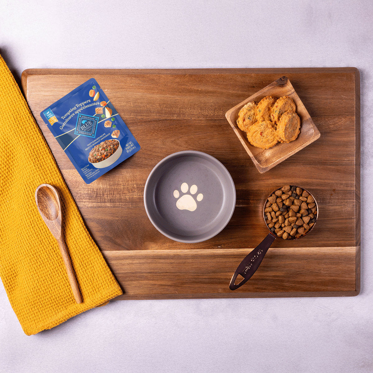 A GIF shows the ingredients being mixed to create a dog-friendly recipe.