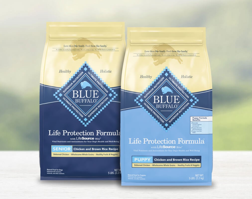 Two bags of Life Protection Formula dog food, labeled Senior and Puppy, sit on a light surface.