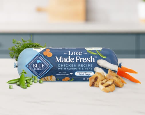 A roll of BLUE Love Made Fresh dog food is pictured on a white kitchen countertop. 