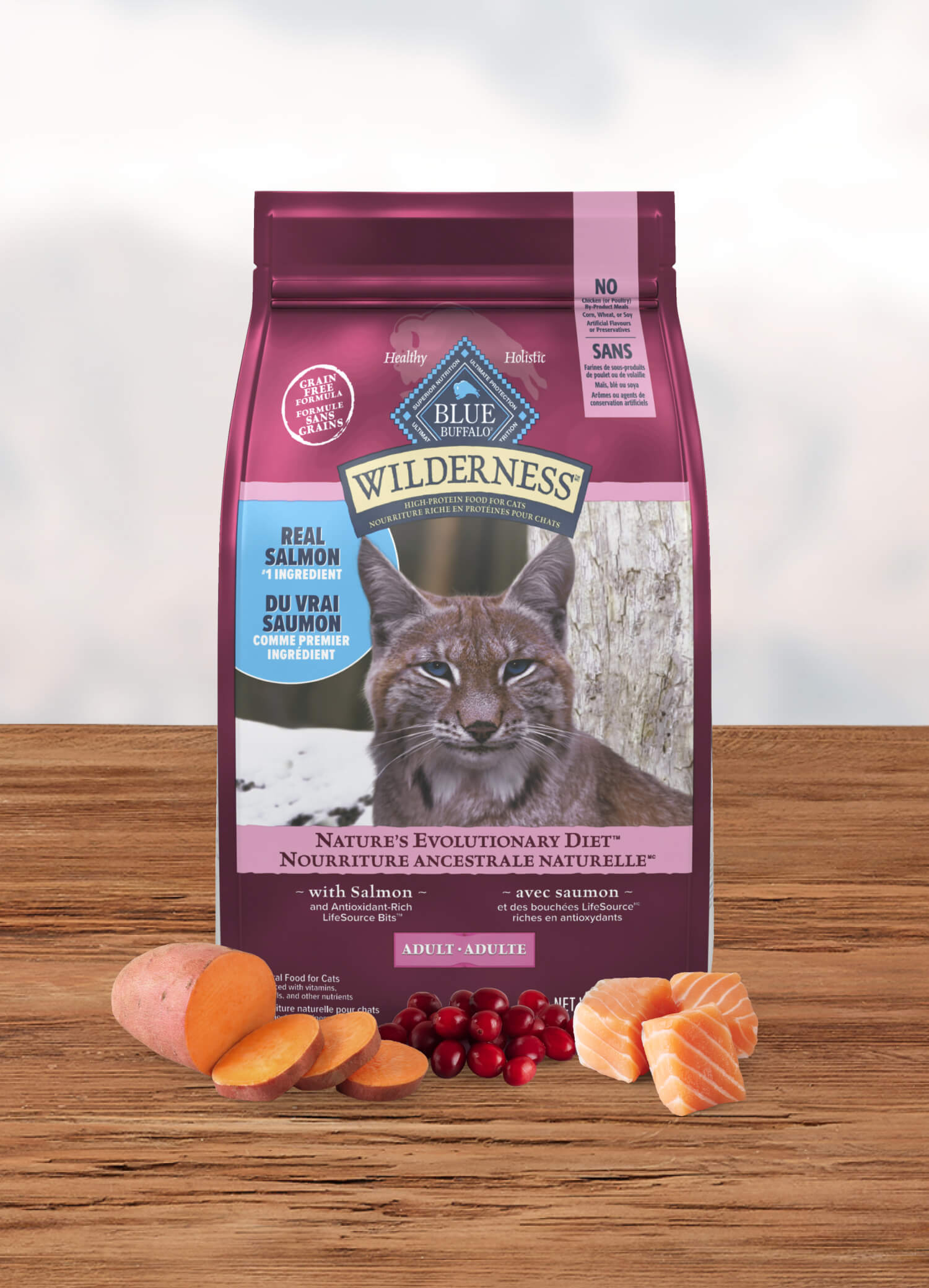 Blue Wilderness cat food with salmon, sweet potatoes, and cranberries sits on the table.