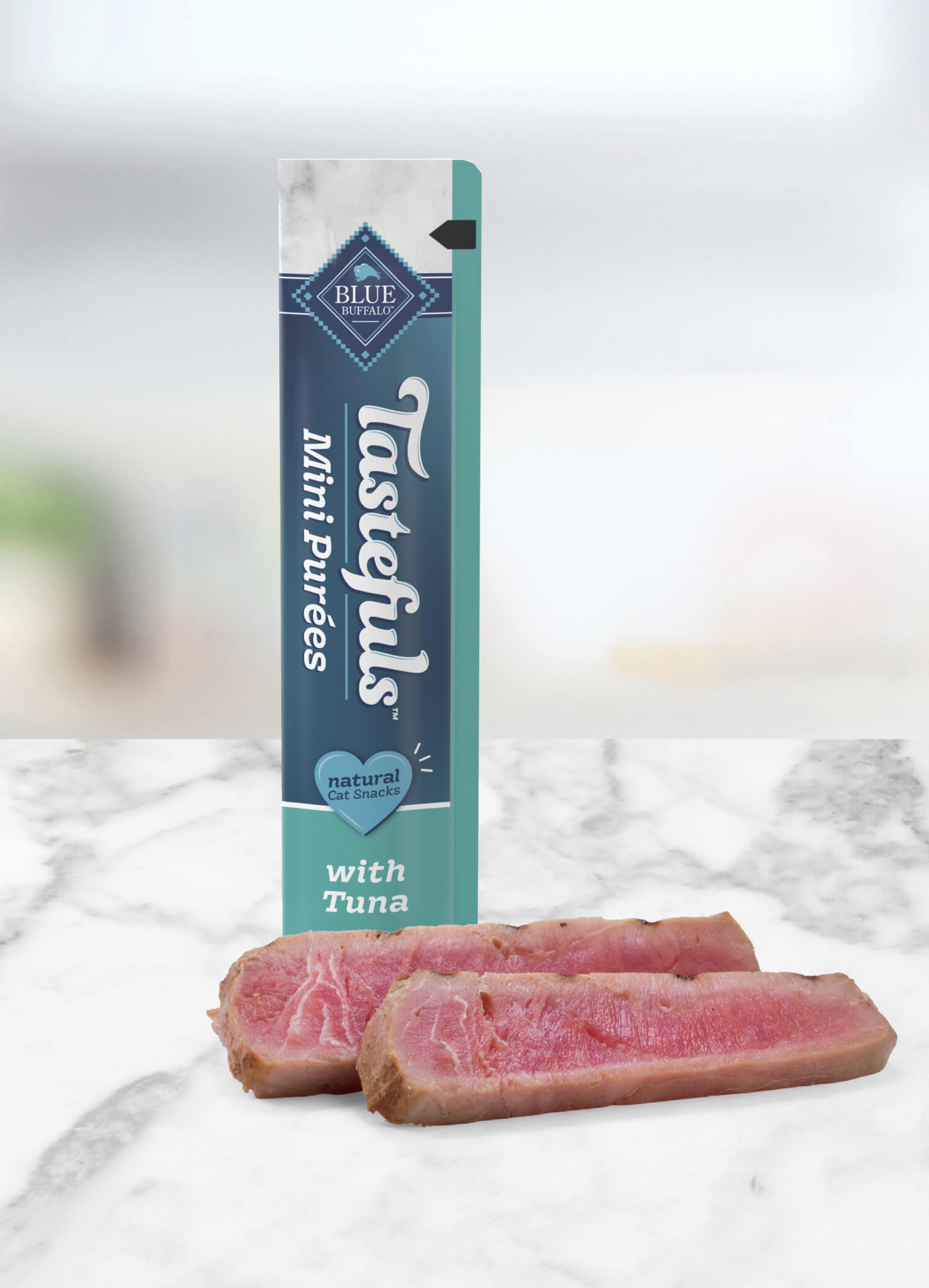 A tube of BLUE Tastefuls Mini Purees and slices of raw tuna are on a kitchen counter