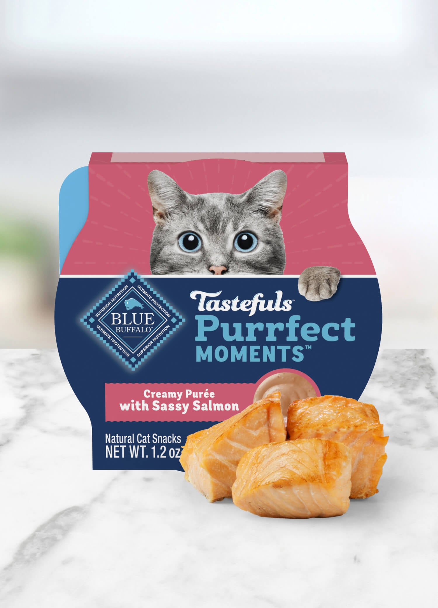Container of BLUE Tastefuls Purrfect Moments cat food topper featuring a wide-eyed, grey cat.
