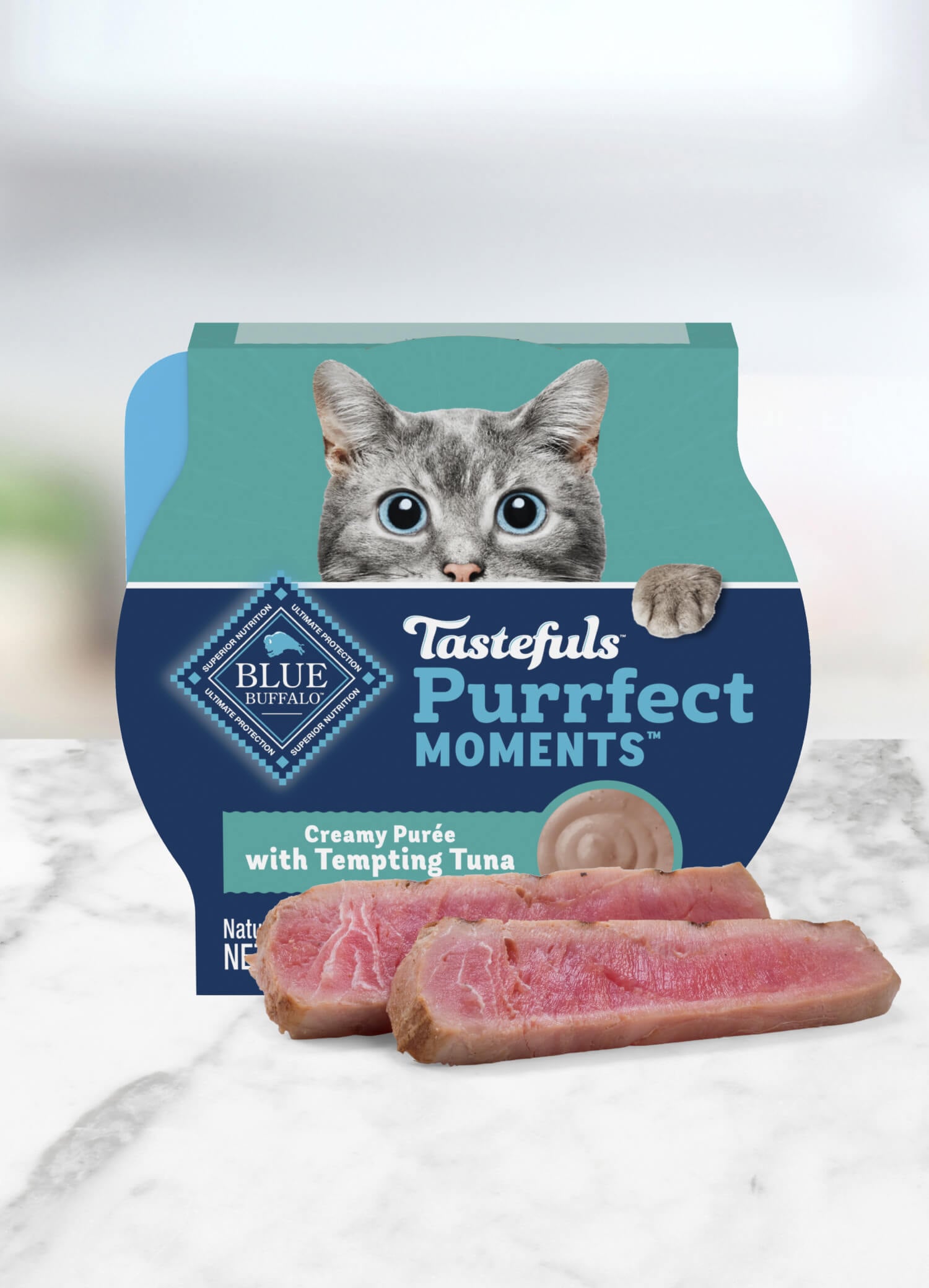 Container of BLUE Tastefuls Purrfect Moments cat food topper featuring a wide-eyed, grey cat.