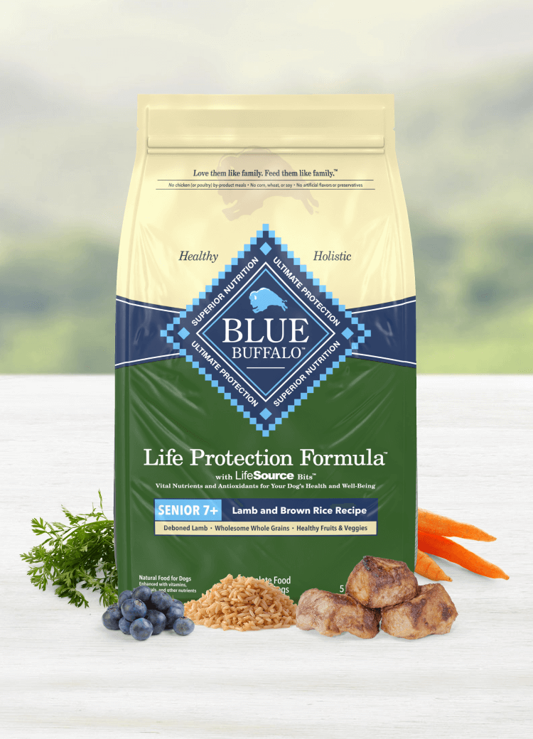 A bag of BLUE dog food shown with tender cuts of lamb and real, fresh fruits and vegetables.