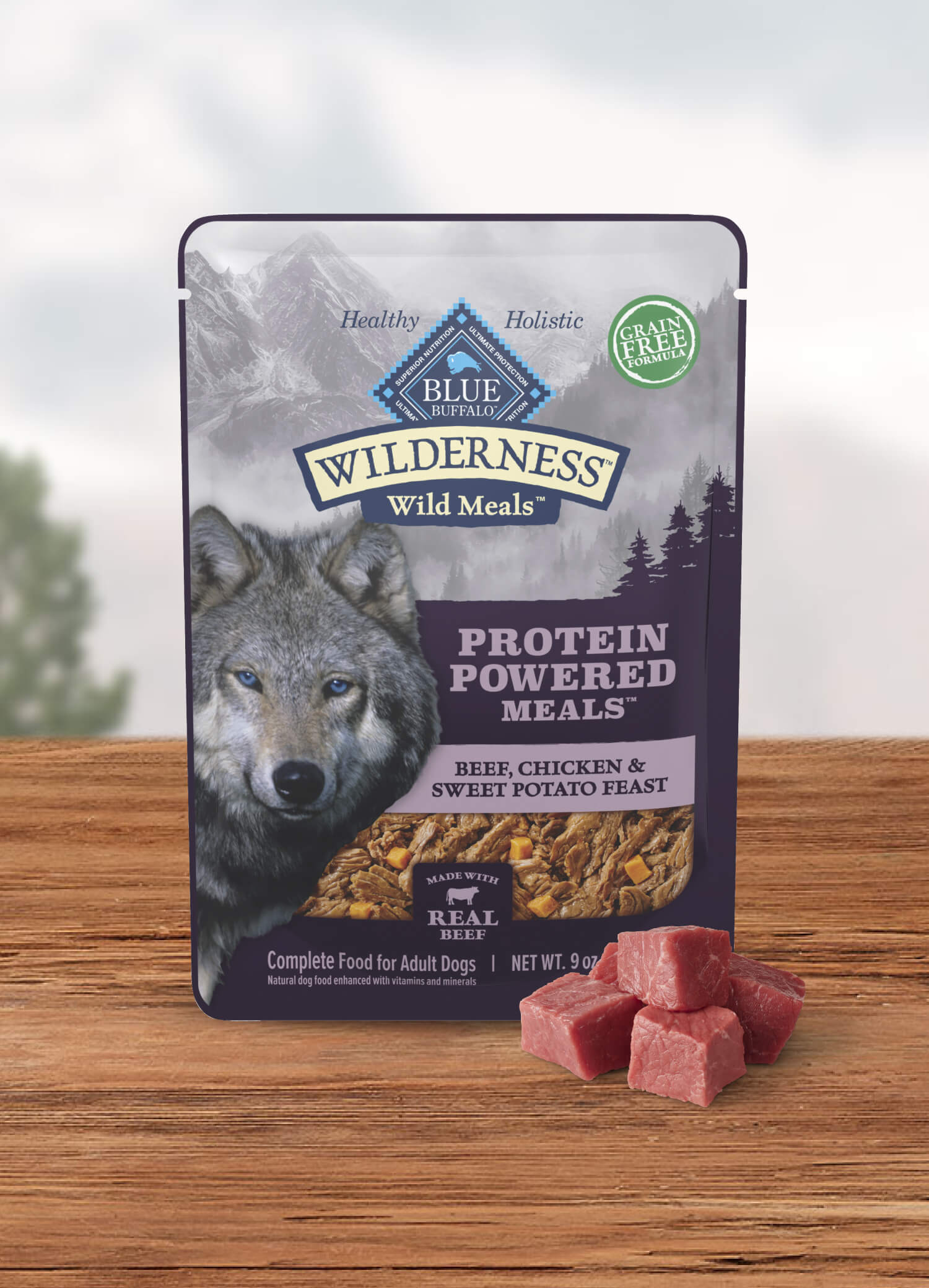 A pouch of BLUE Wilderness Wild Meals and a few cuts of raw beef.