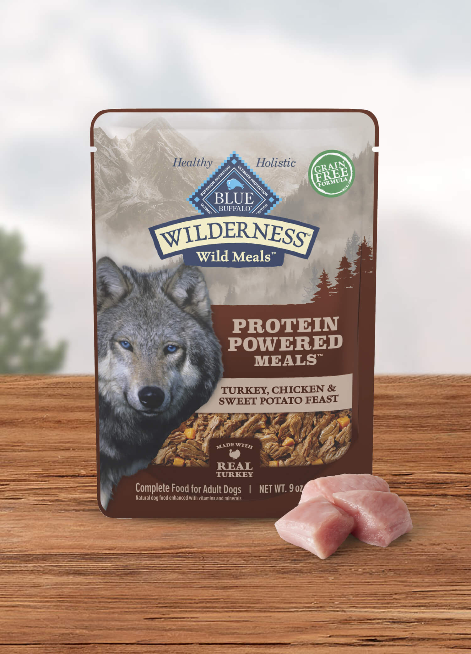 A pouch of BLUE Wilderness Wild Meals and a few cuts of raw turkey.