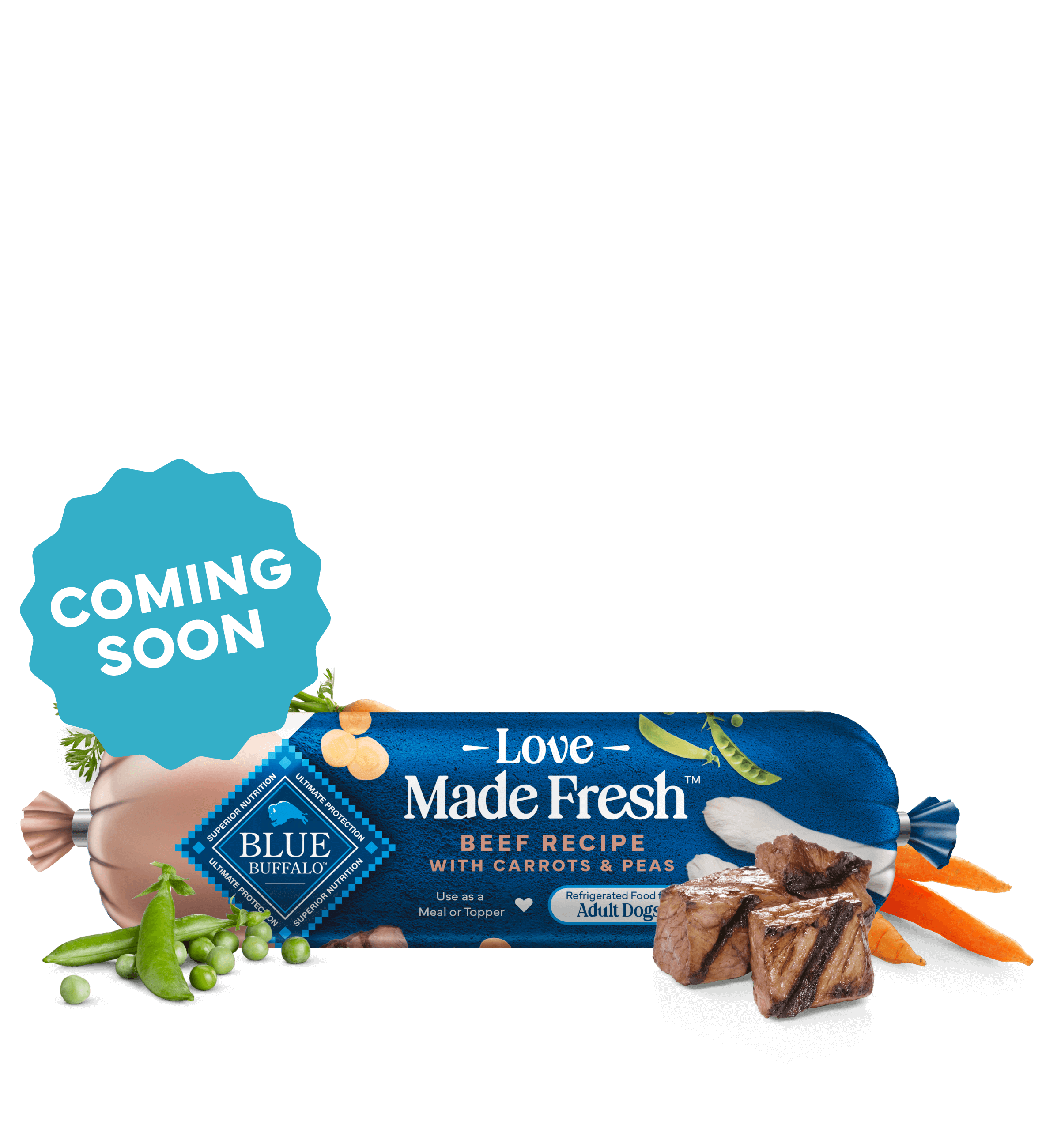 A roll of Love Made Fresh beef recipe is surrounded by parsley, chunks of seared beef, carrots, and peas on a countertop.