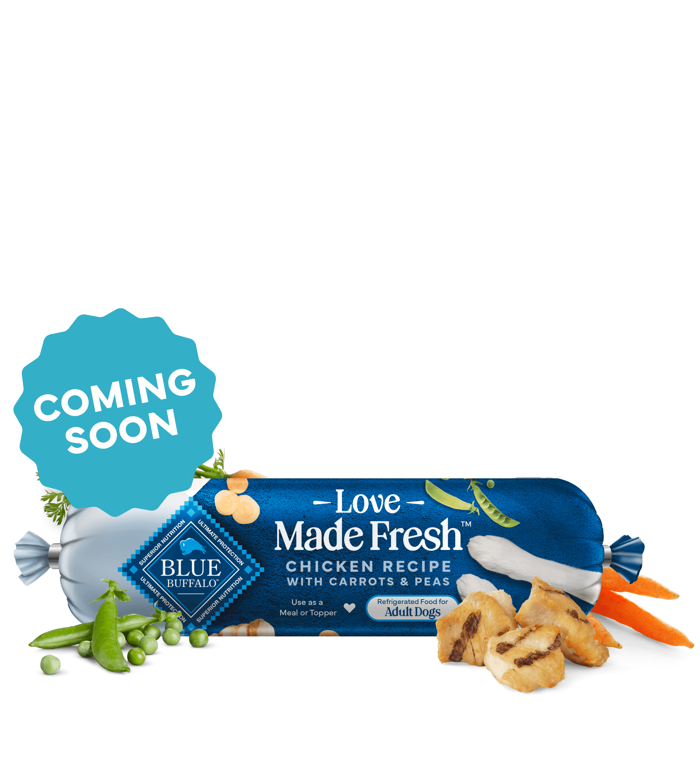 A roll of Love Made Fresh chicken recipe is surrounded by parsley, chunks of seared chicken, carrots, and peas on a countertop.