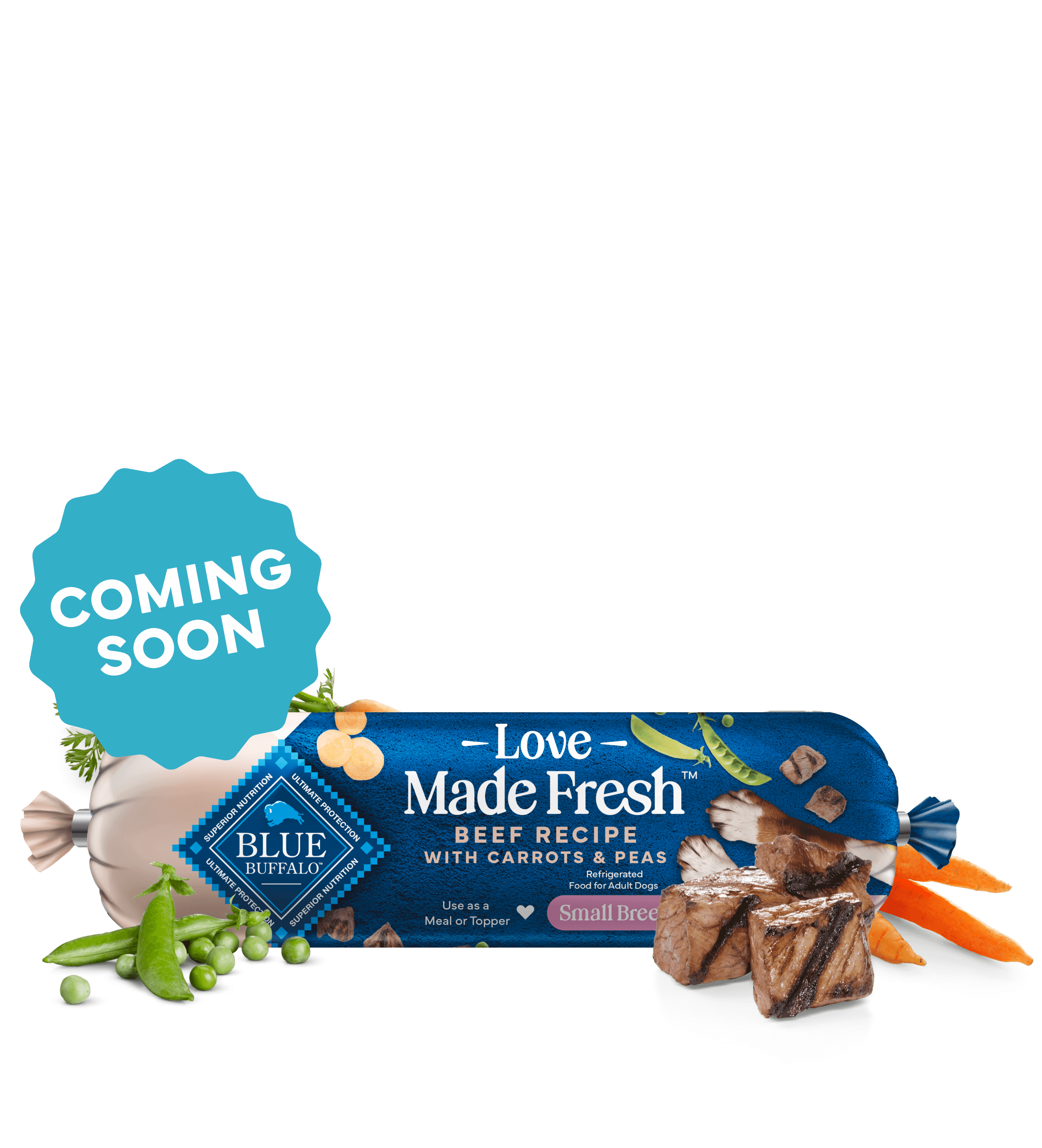 A roll of Love Made Fresh beef recipe is surrounded by parsley, chunks of seared beef, carrots, and peas on a countertop.