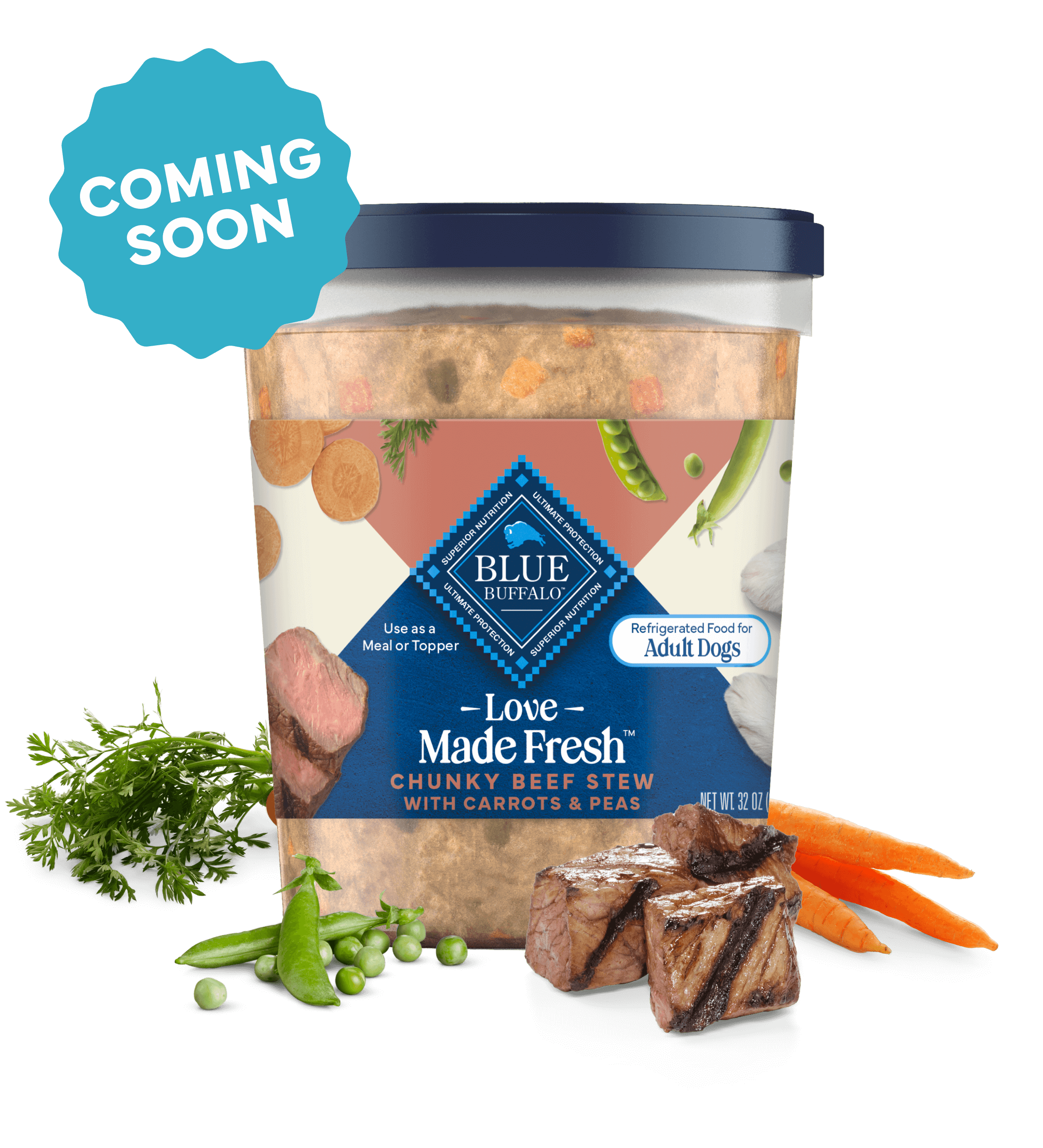 A tub of Love Made Fresh beef stew is surrounded by parsley, chunks of seared beef, carrots, and peas on a countertop.