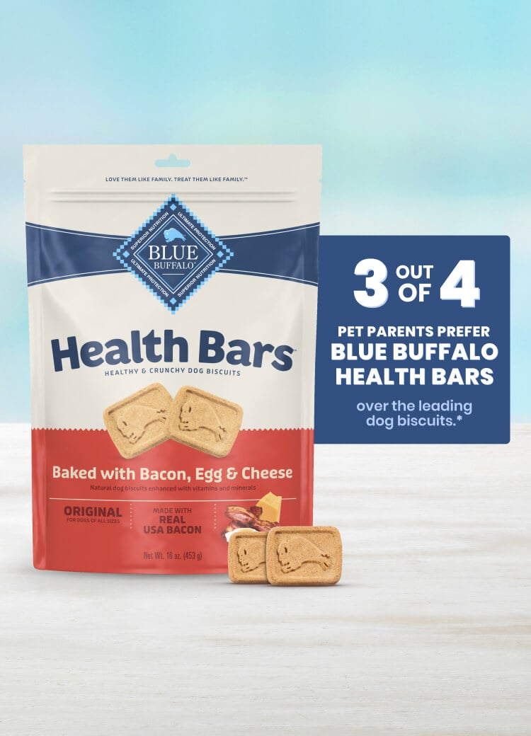A bag of Health Bars dog biscuits with bacon, egg, and cheese flavor sits on a table.