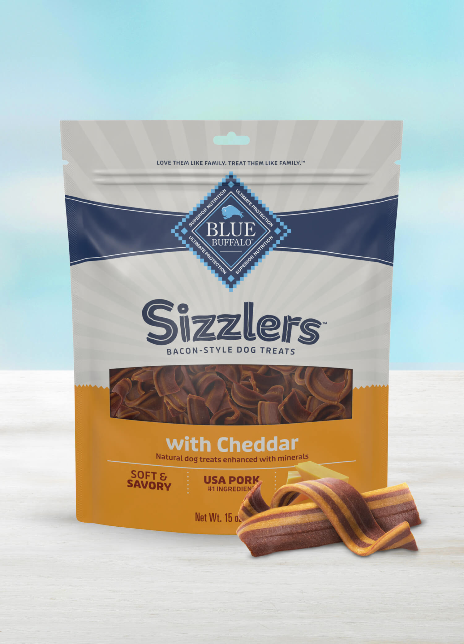 A bag of BLUE Sizzlers Bacon-Style Dog Treats Cheddar Recipe