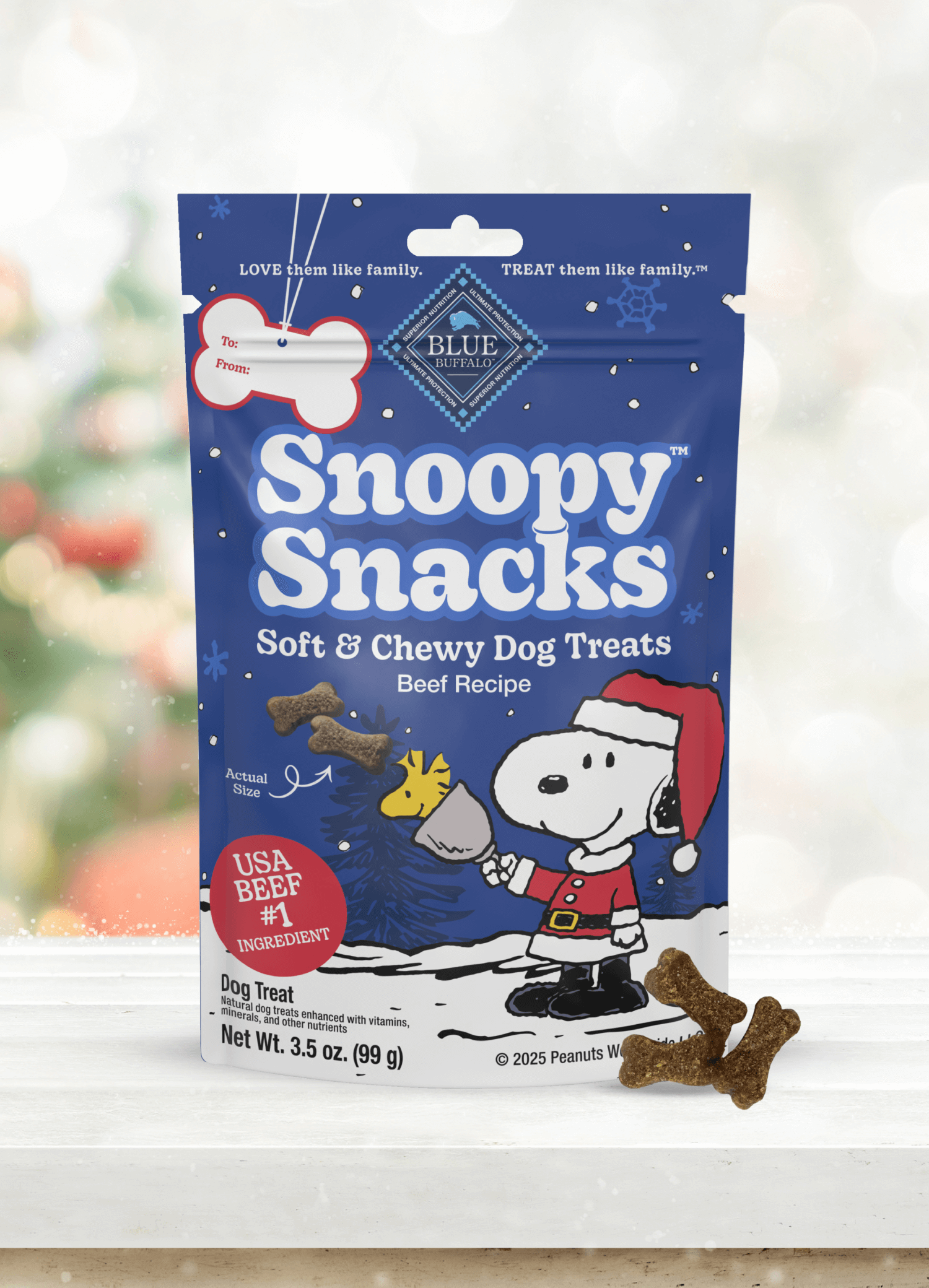 A bag of Snoopy Snacks soft & chewy dog treats, beef recipe, with tasty treats in front.