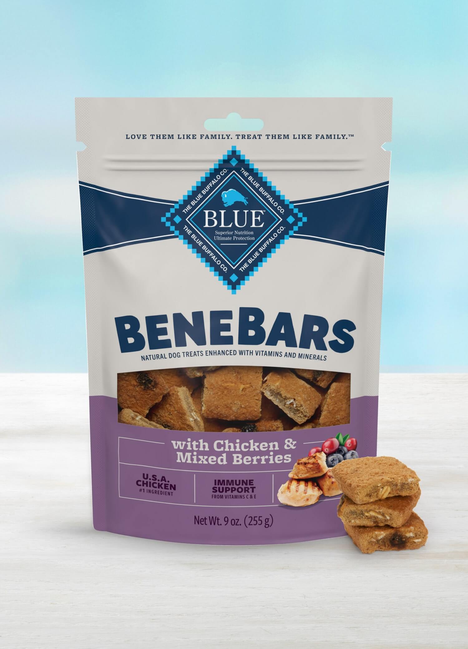 A bag of Blue Benebars dog treats with chicken and mixed berries on a light surface.