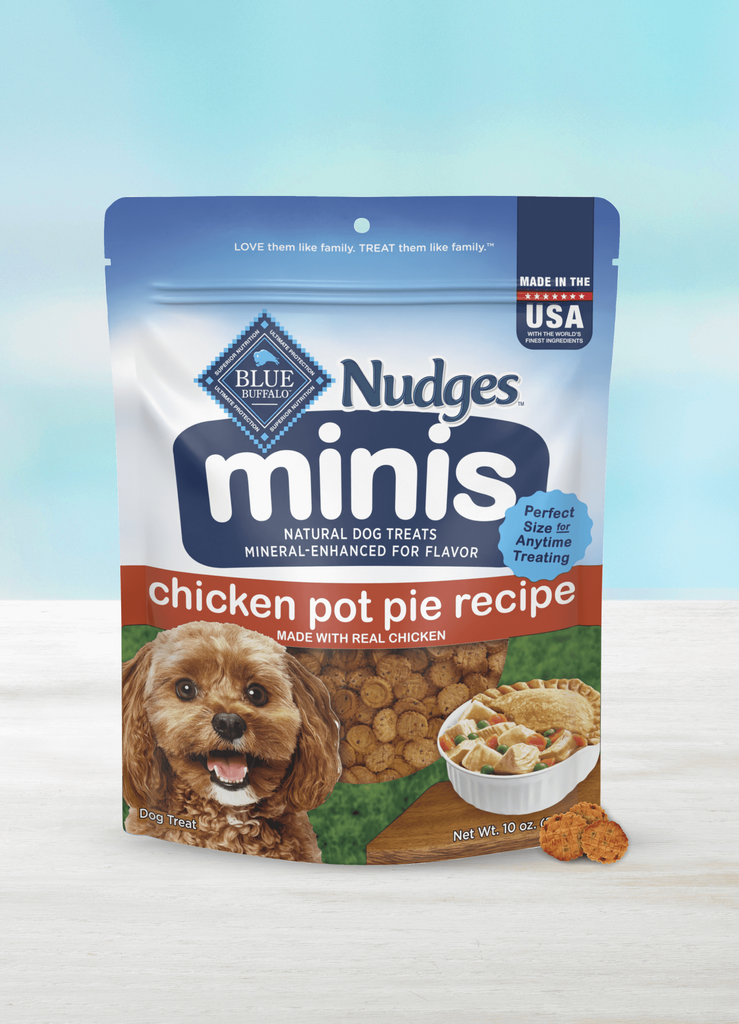 A pack of BLUE Nudges minis chicken pot pie recipe dog treats and a few loose Nudges mini treats.