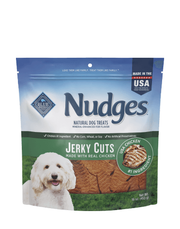 A bag of Nudges Jerky Cuts dog treats with real chicken, featuring a happy dog and hearty treat slices.