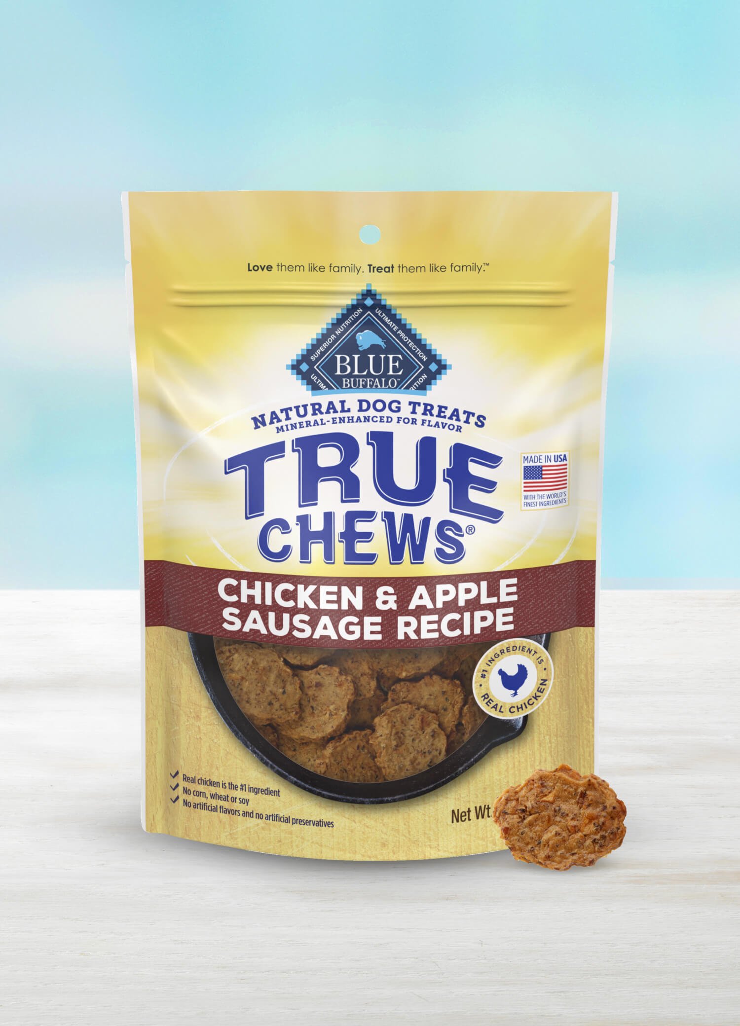 A bag of True Chews Chicken & Apple Sausage Recipe natural dog treats sits on a light surface.