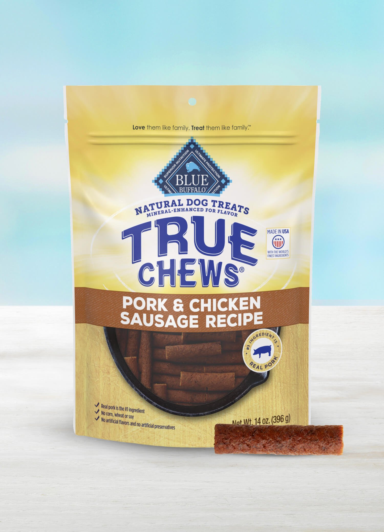 A bag of True Chews Pork & Chicken Sausage Recipe dog treats with a treat stick next to it.