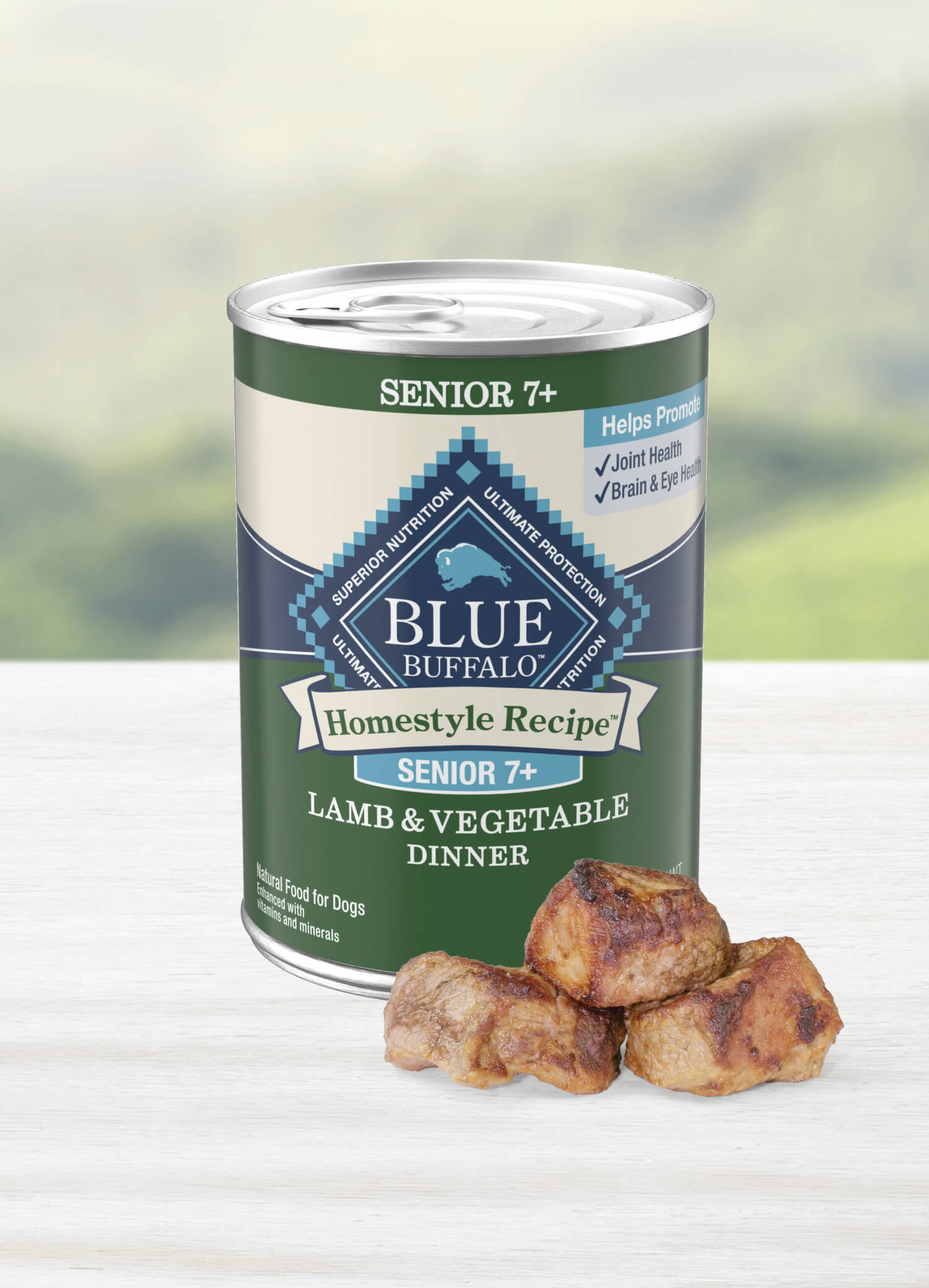 Three chunks of juicy lamb are stacked neatly in front of a can of BLUE Homestyle Recipe Turkey & Vegetable Dinner senior dog food.