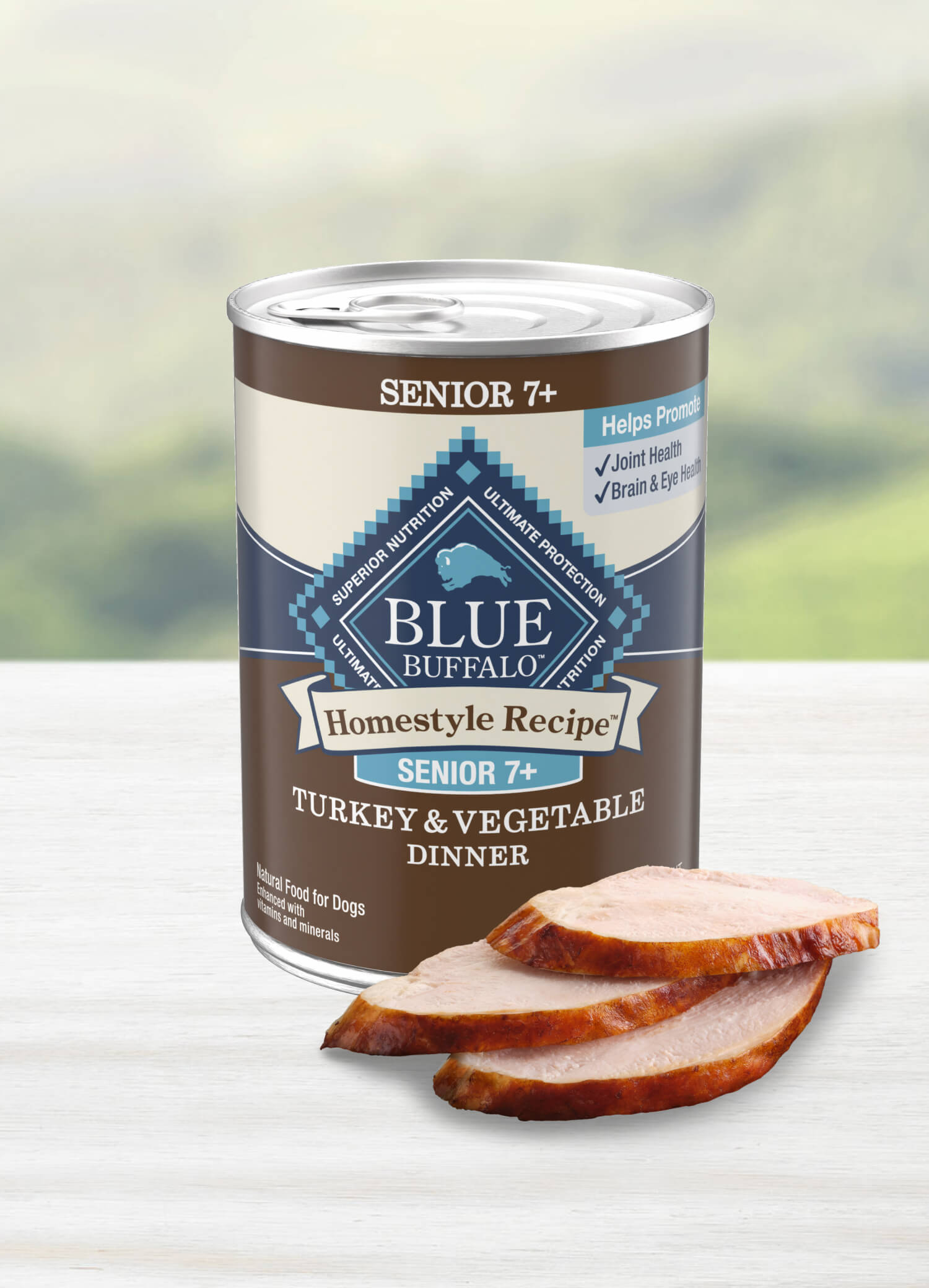 Three slices of juicy turkey are stacked neatly in front of a can of BLUE Homestyle Recipe Turkey & Vegetable Dinner senior dog food.